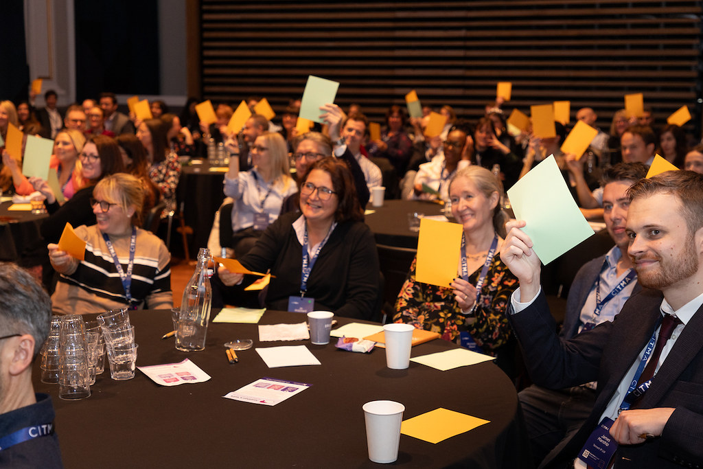 AC24 delegates holding cards.jpg 1