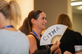 Paralegal conference woman with white fan.jpg