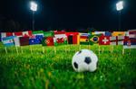 a football with the flags of the world cup 2022 teams